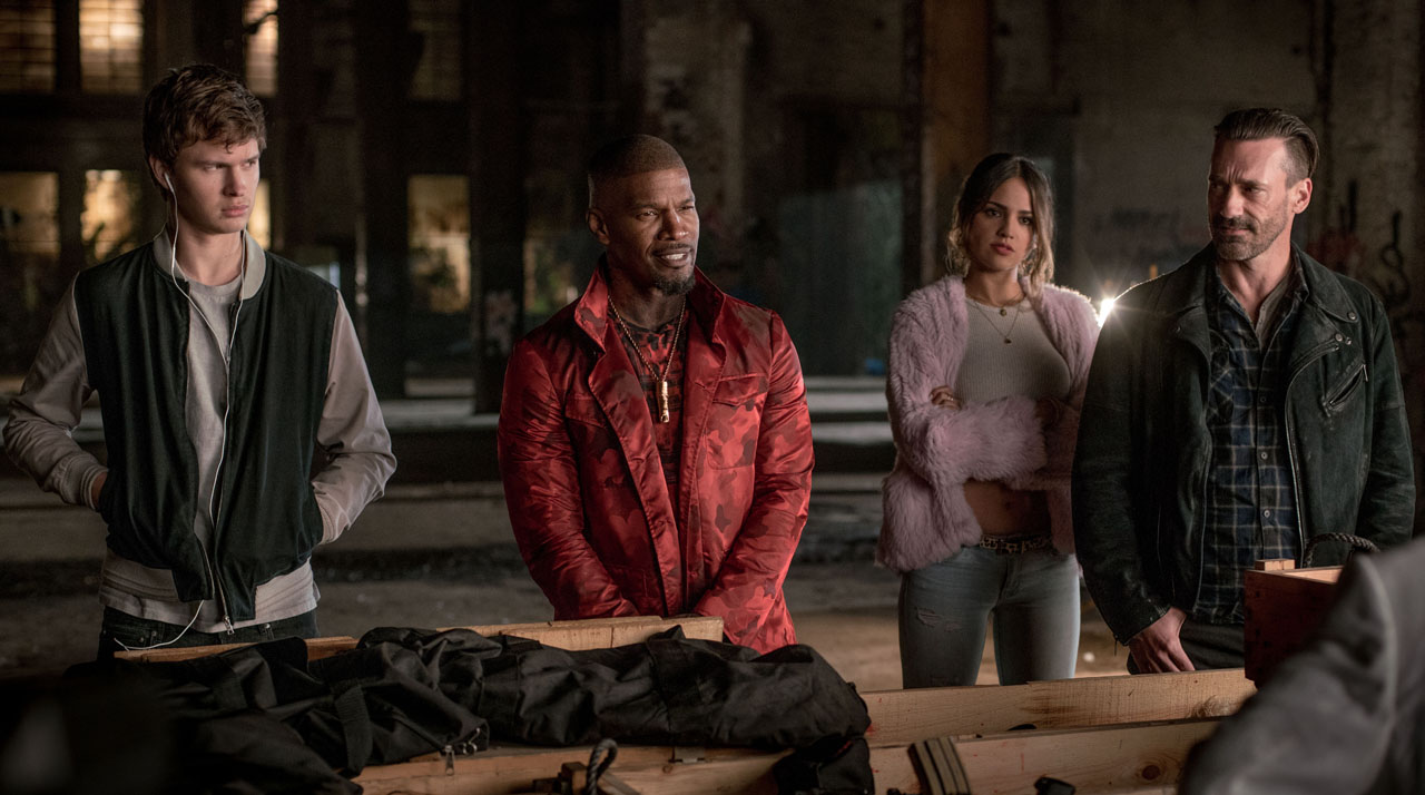 (l to r) Baby (ANSEL ELGORT), Bats (JAMIE FOXX), Darling (EIZA GONZALEZ) and Buddy (JON HAMM) in the abandoned rail yard to negotiate a deal in TriStar Pictures' BABY DRIVER.